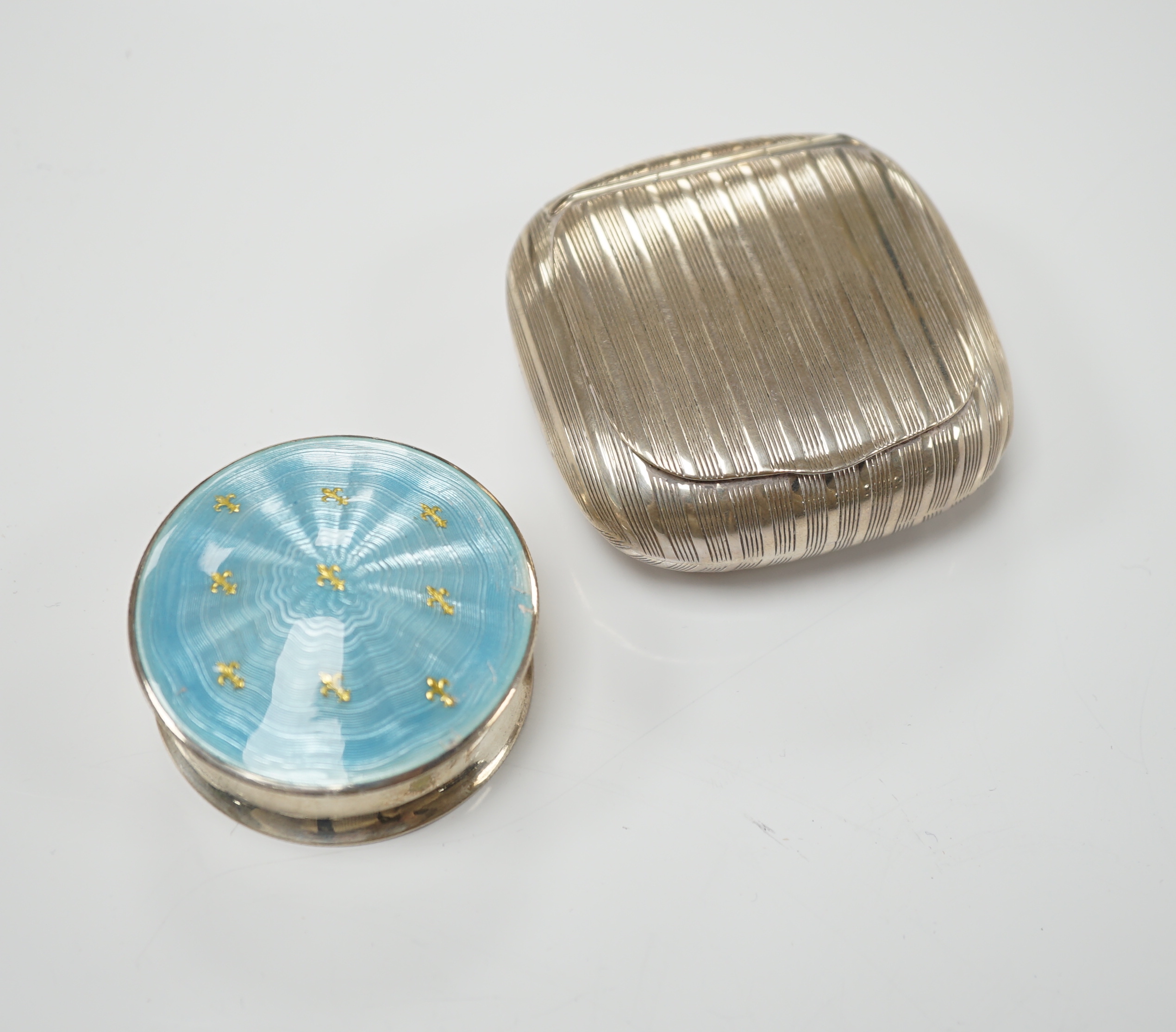 A George V silver and enamelled circular pill box and cover, Birmingham, 1910, 48mm and a German 900 standard white metal tobacco? box.
